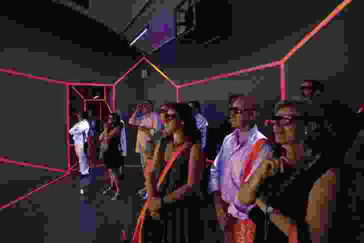 Guests of the pavilion don 3D glasses to view the photography on display.