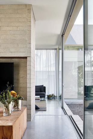 The house is permeable throughout, with the doors designed as discreet pivots and generally left open.