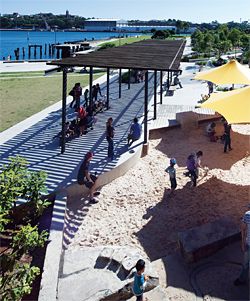 View north-west toward Elizabeth Macarthur Bay. One of three shade structures covers the promenade alongside the playground. Image: Brett Boardman