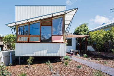 Rather than demolish the original cottage, the designers and their clients opted to refresh
it with an extension that addresses the street and landscape.