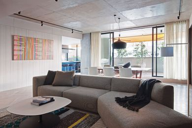 Concrete ceilings complement parquetry floors in the living room. Artwork: Sara Hughes, World Wide Optimism (Asia Pacific), (2010).