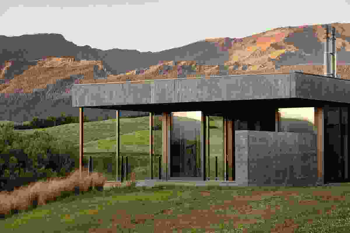 On the inside and out, a combination of Corten steel, shuttered concrete and schist in the home gives a rustic look that merges nicely with the landscape.