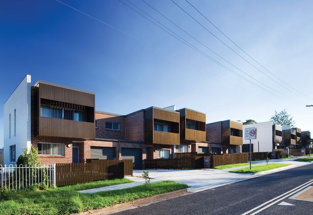 The project combines two-storey townhouses fronting Hope Street with single-storey villas accessed via a side street.