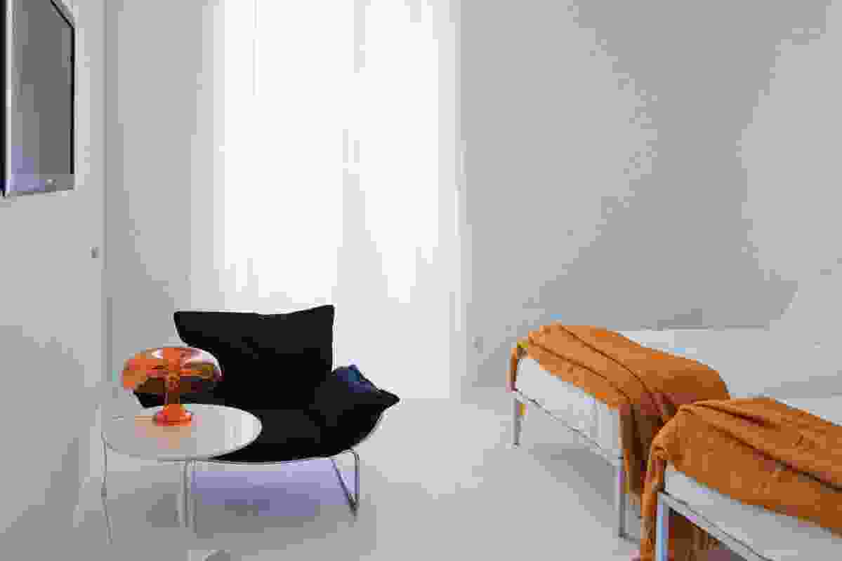 The lighting and mood in the rooms is dramatic, with some in bright white and some in grey shadows.