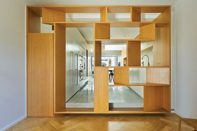 A timber screen-cum-portal acts as a threshold between old and new.