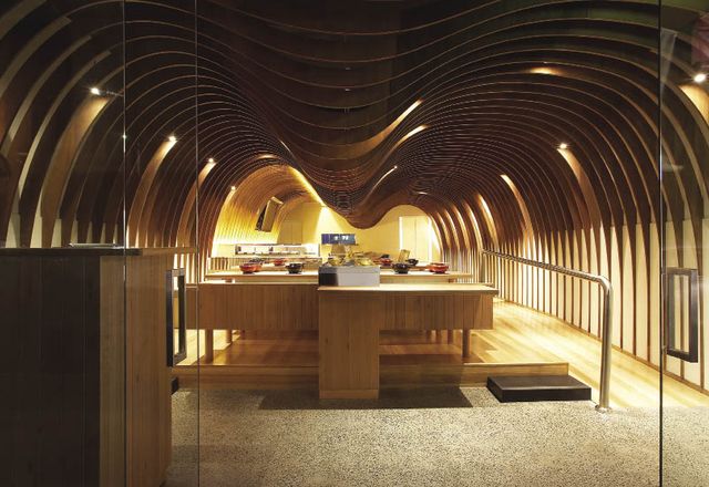 Curving plywood panels arc across the ceiling of Takada’s Cave restaurant.