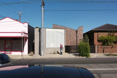 Industrial in aesthetic and sitting between a corner shop and a suburban bungalow, this new house has no setback from its West Brunswick street.
