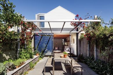 Custom steel-framed sliding doors open onto a small but sunny courtyard.