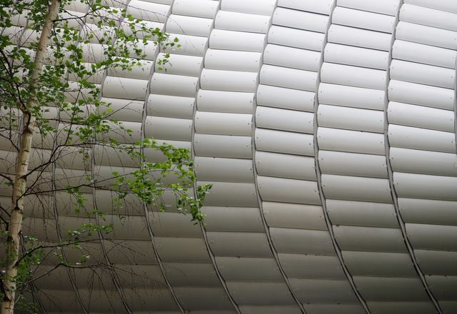 A perforated aluminum screen covers the Pathé Foundation by Renzo Piano Building Workshop to provide privacy and sunshading.