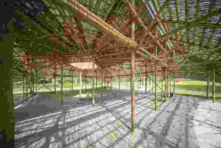 The pavilion is supported by a lattice-like bamboo structure.