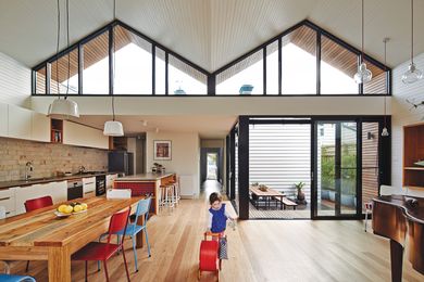 Striking clerestory windows funnel northern light into the extension, the winter sun falling onto the dining table.