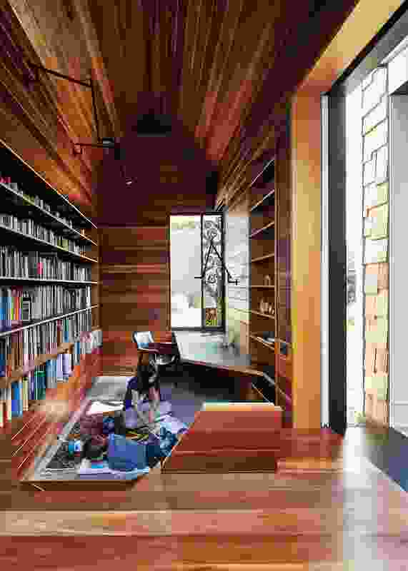 The library is sunken into the ground and provides a vantage point through to the courtyard. Stained glass window: Leigh Schellekens.