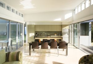 The living room, between verandah and courtyard, is cross-ventilated and naturally lit. Operable clerestory windows expel the hot air.
