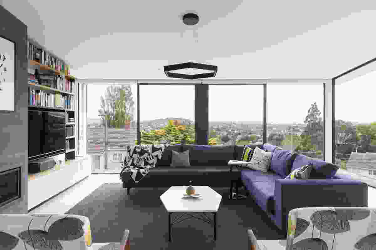 Three storeys above the street, the open-plan living area boasts panoramic views back across the city and surrounds. 