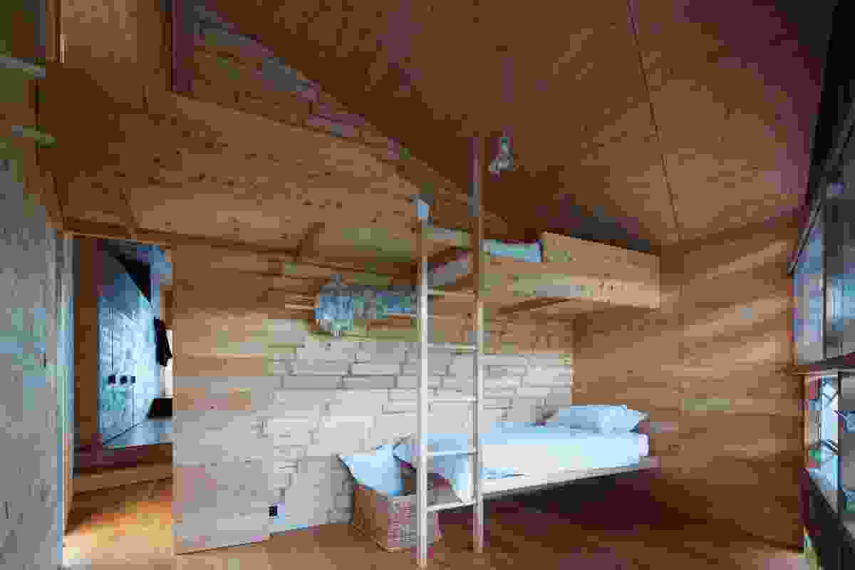 A bedroom and bunks in Shearer's Quarters, lined in reclaimed apple crate timbers.