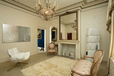 Johnston’s sitting room and Mirror, Mirror no. 2 (2008–09) featuring B&B; Italia armchair by Patricia Urquiola and Edra bookcase.