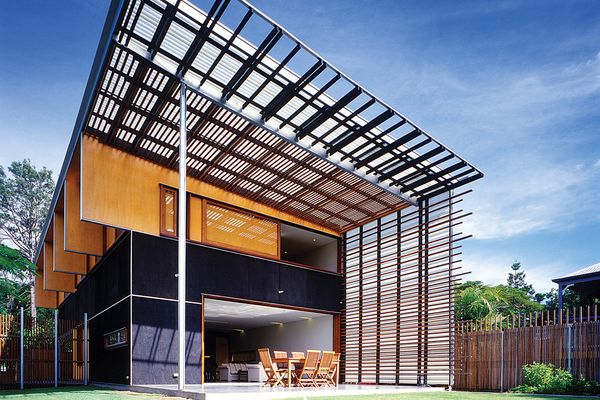 A dramatic outdoor double-height volume gives the modest house a sense of space and gesture.