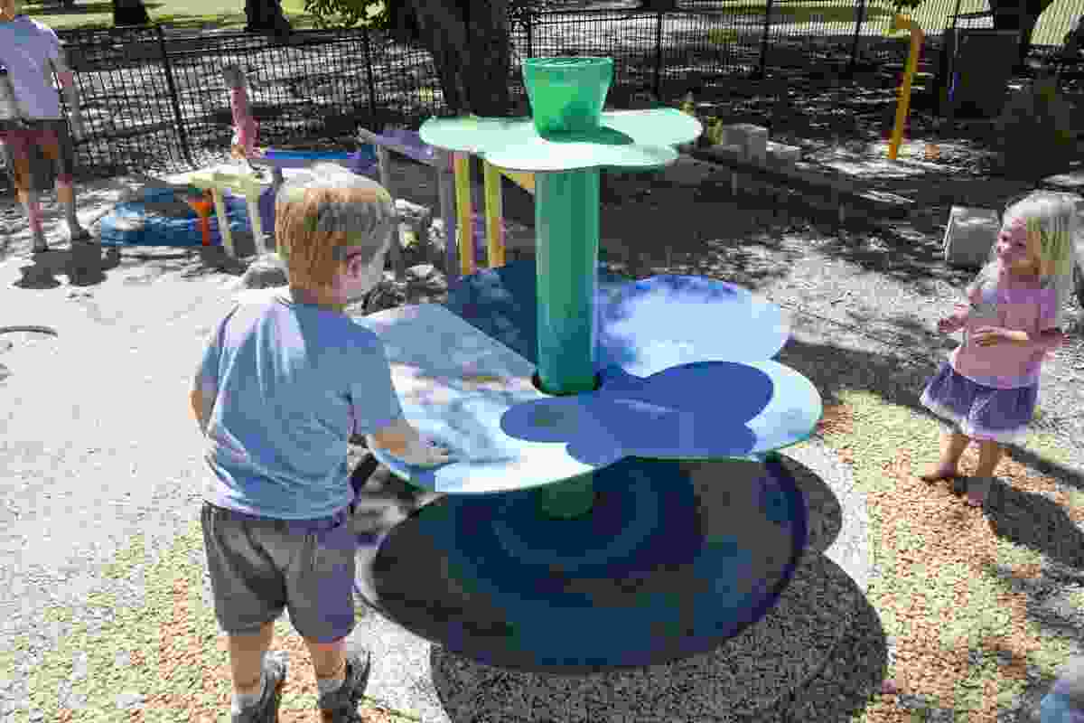 Water play provides sensory stimulation and cool relief on a hot day.
