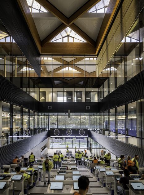 The dramatic, steeply tiered auction hall provides a commanding space for merchants.