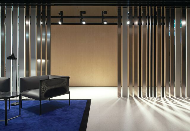 Taking the form of a barcode, aluminium screens in three finish tones enclose public areas.
