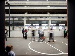 A partial basketball court forms a flexible outdoor space.