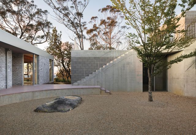 The existing 1970s house and the new guesthouse are brought together by curved lines that establish a stage-like courtyard.