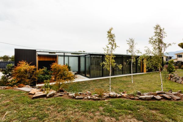 While the house is designed to merge with its landscape, it is also clearly delineated by black framing.