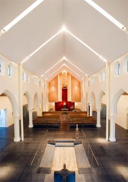 Looking along the Chapel of the Blessed Sacrament. The baptismal font in the foreground is by Anne Ferguson and the screens by Robin Blau.