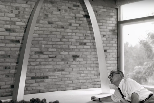 Architect Eero Saarinen with a model of the St. Louis Gateway Arch.