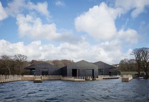 Venerating the natural context, the architects opted to break the project’s scale down to a granular cluster of five pitched-roofed blocks.