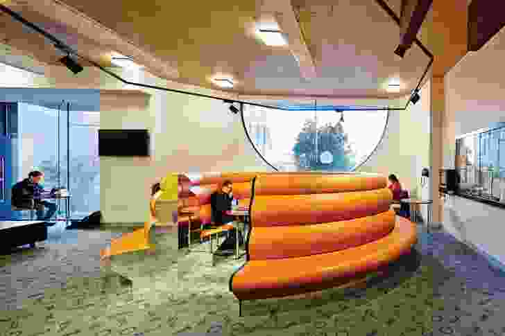 A circular lounge in the student commons room coils like a snake.