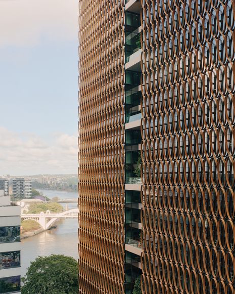 Terraces register as small voids, interrupting the screen’s continuity and giving the elevations a more open and inhabited character.