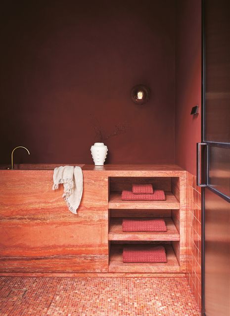 Burgundy and terracotta tones feature in the washroom and steam room.