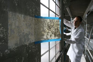 Jorge Otero-Pailos cleaning the wall of the Alumix factory in 2008. 