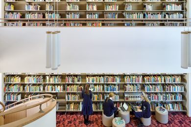 Round edges, including on the ottomans and cylindrical pendant lights, mimic the fluid lines of the spiral staircases.