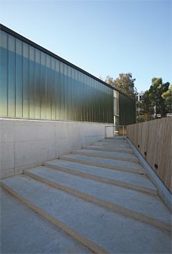 A series of steps along the east facade lead to a timber deck.