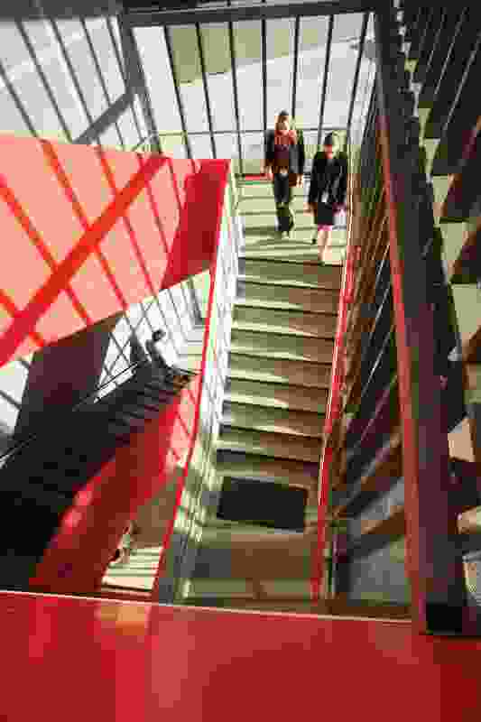 Circulation at the western end of the building is defined by a red-orange ribbon, which links stair to entry.