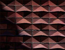 The three dimensional patterned brickwork of the side walls.