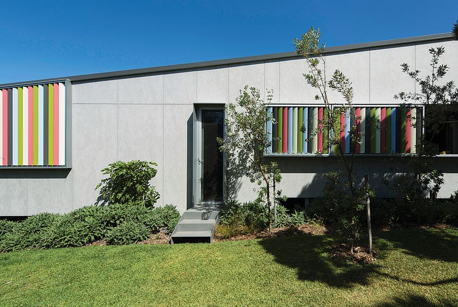 Vertical sun blades, in a fun palette of foliage-inspired colours, draw the garden into the fabric of the building.