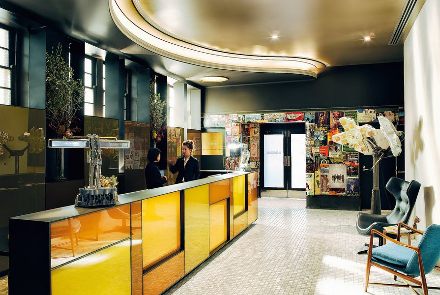 Once a pokies room, the reception area features a reception desk made from illuminated amber-coloured panes of glass.