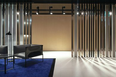 Taking the form of a barcode, aluminium screens in three finish tones enclose public areas.