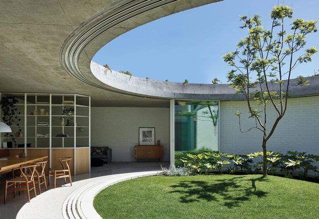 A circular courtyard is the centrepiece of the extension, bringing light and ventilation to the living spaces.