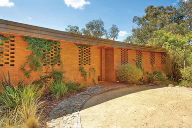 The terse facade with brick-screened window openings was explored earlier by Grounds in his design of Melbourne’s NGV.