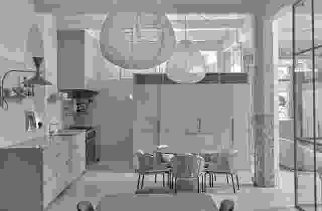 In the kitchen, the atypical design features a round table instead of an island bench.