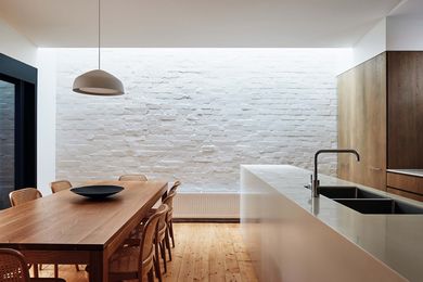 A long skylight in the dining space illuminates the restored brickwork to dramatic effect.