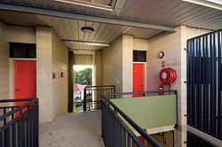  An upper-level circulation space. The detailing of the stairwell wall allows for small recesses at the entry point of each of the apartments. Image: Graham Philip 