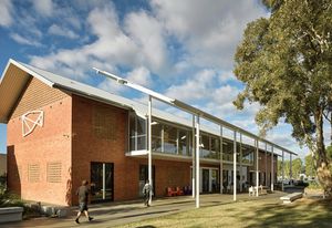 The new work is clearly articulated off the side of a 1960s red-brick building. A fly roof and colonnade encourage occupation of the outside space.