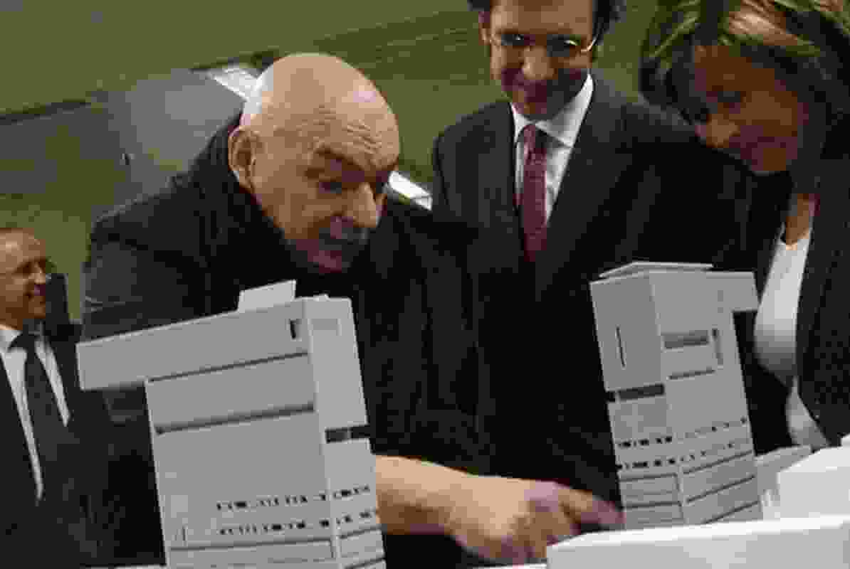 A scene from The Compeitition  where Jean Nouvel reveals his model to the Andorran minister of culture.