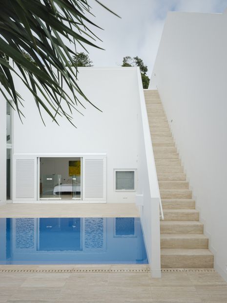 The main bedroom is separated from living areas by the pool and courtyard.