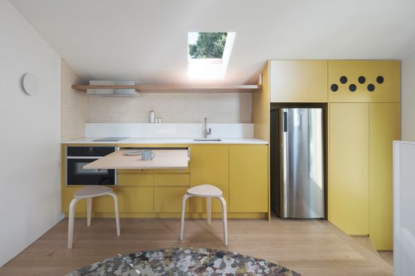 The compact kitchen is tucked into the sloping roofline.